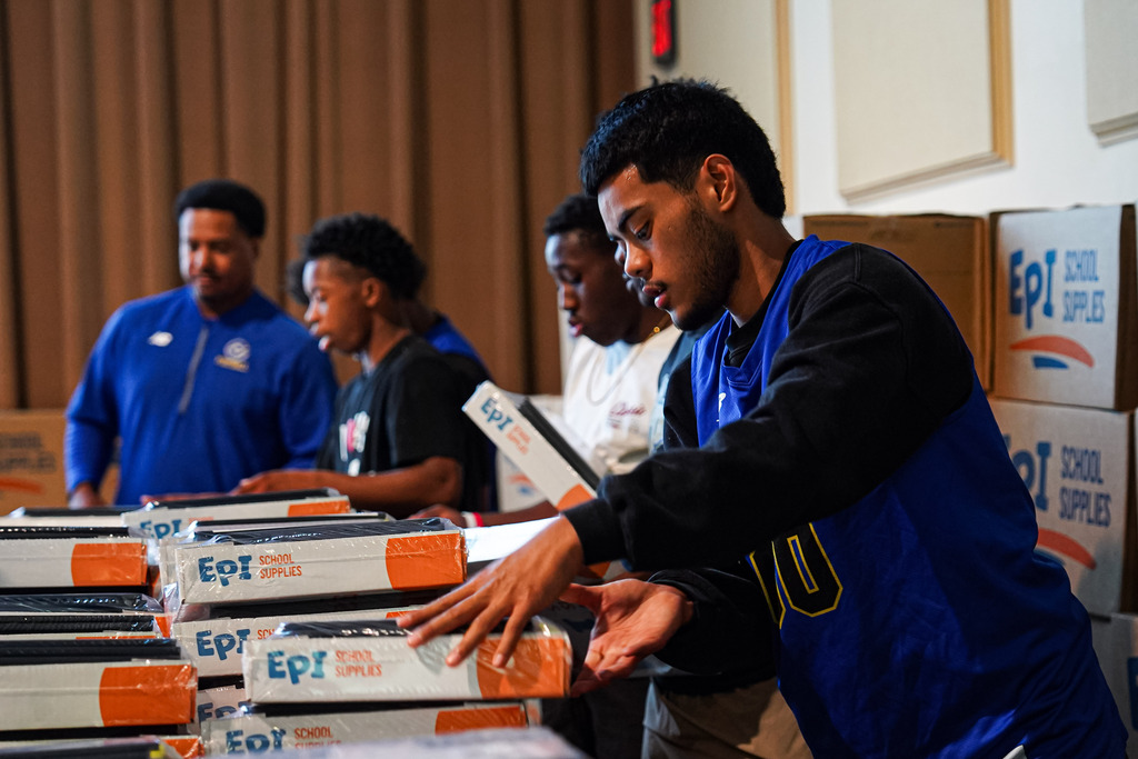 students helping with supplies