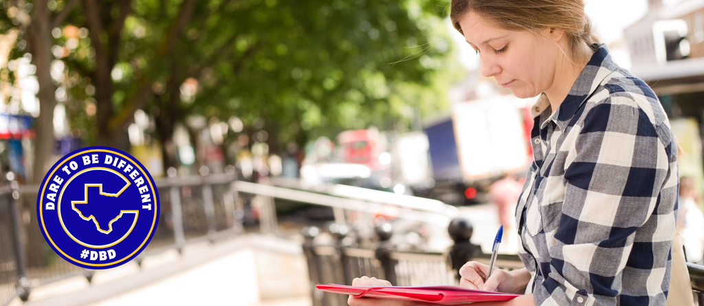 Woman holding a clipboard filling out a form