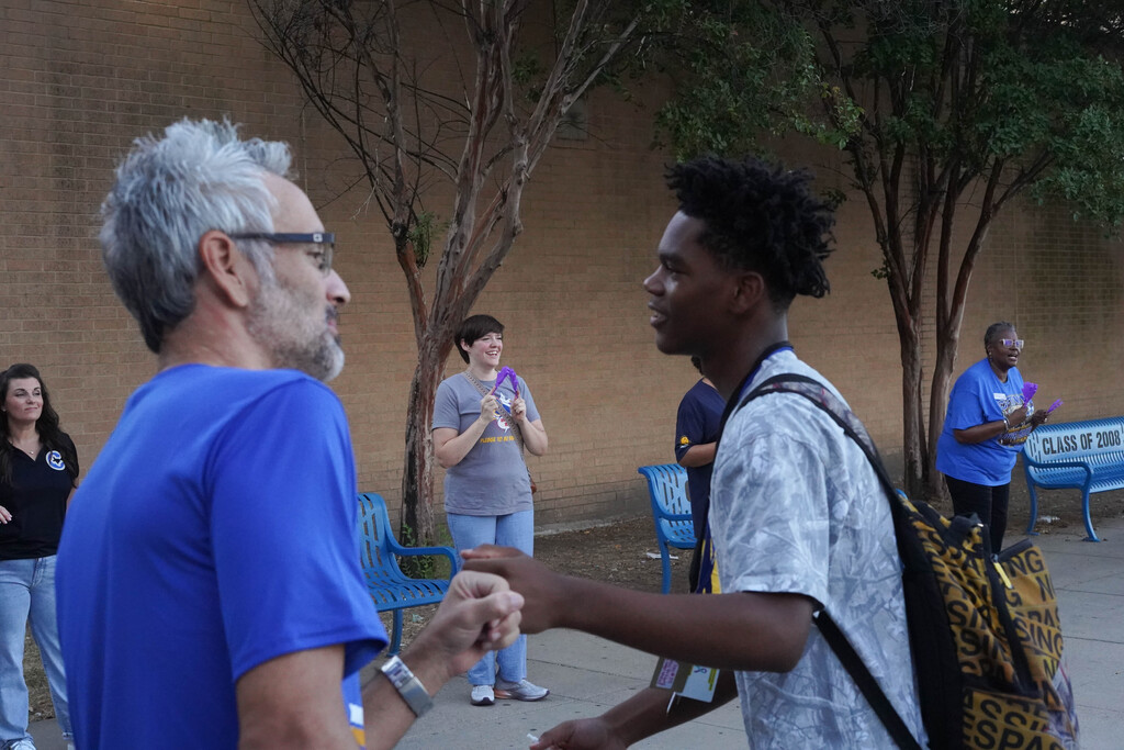 A student at receives a fist bump on You Matter Day at Corsicana High School