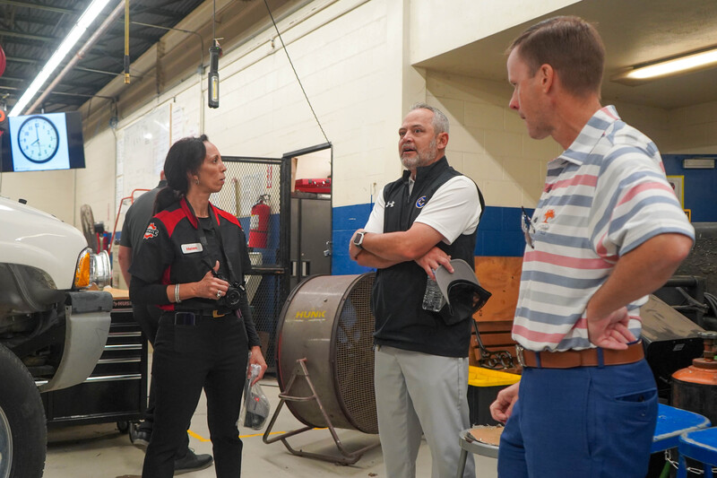Photograph shows an instructor and CHS students gathered in a workshop
