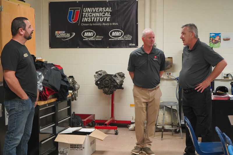 Photograph shows an instructor and CHS students gathered in a workshop