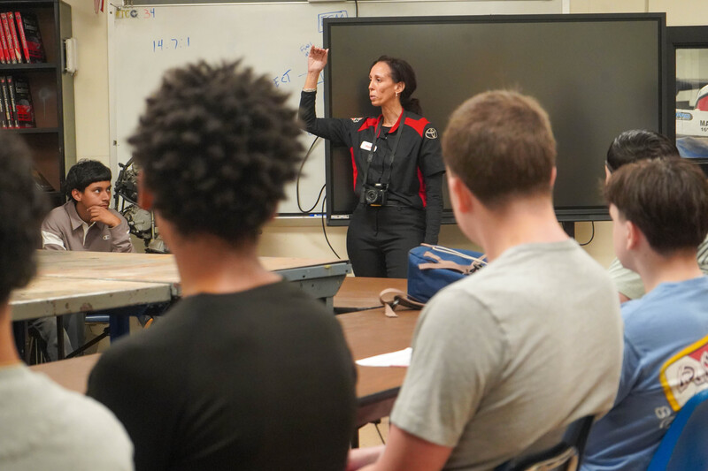 Photograph shows an instructor and CHS students gathered in a workshop