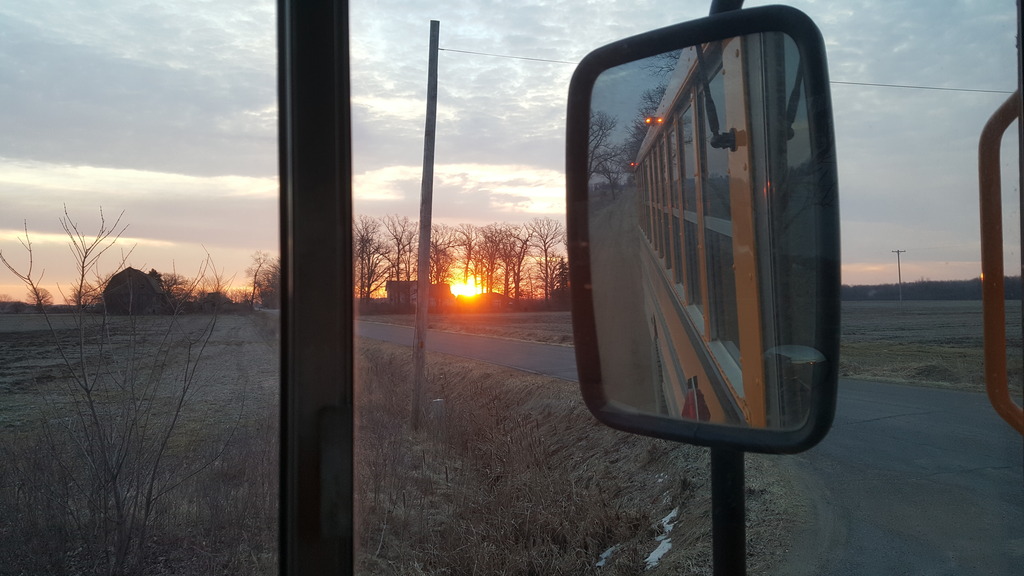 Bus picture with bus mirror and sunrise