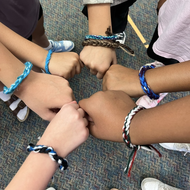 girls arms with yarn bracelets