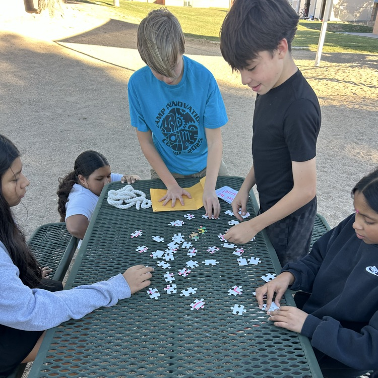 students figuring out puzzle to unlock clues