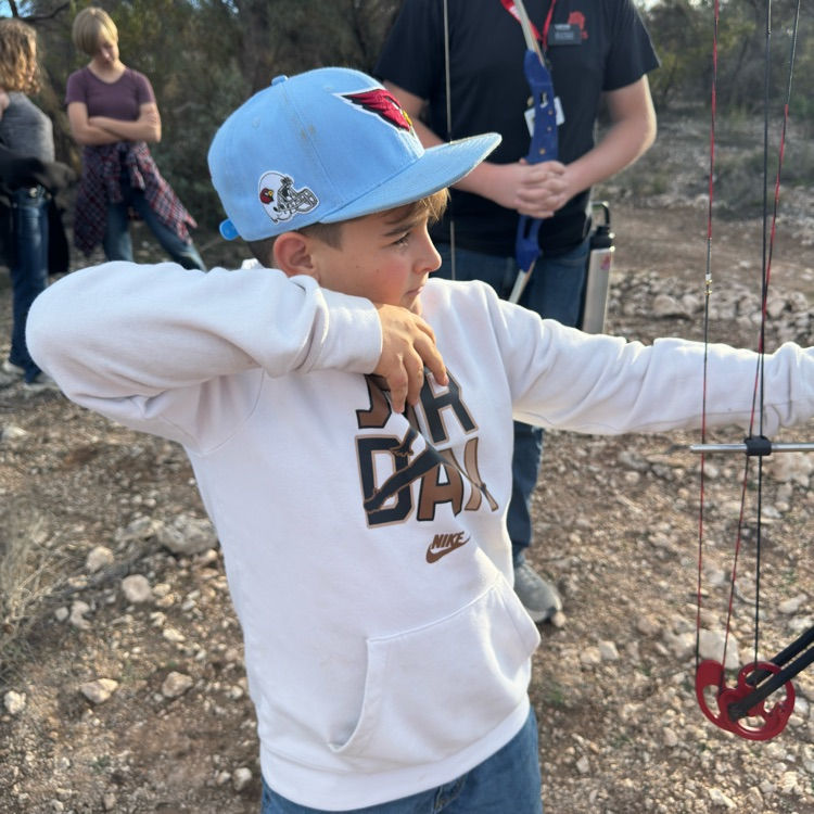student aiming bow