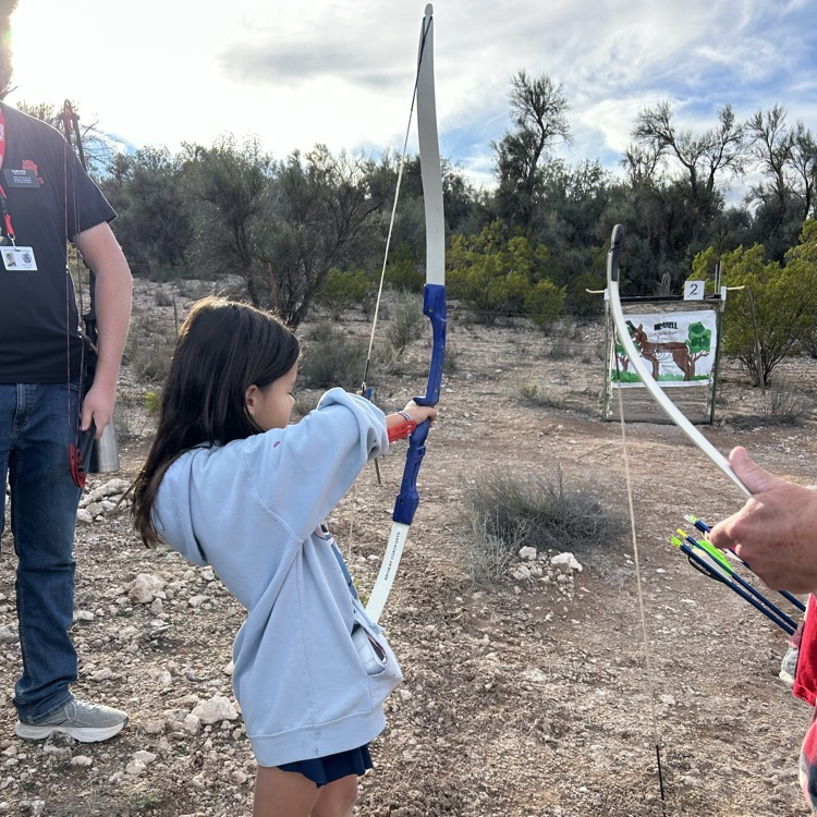 student aiming bow