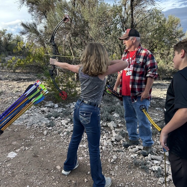 student aiming bow