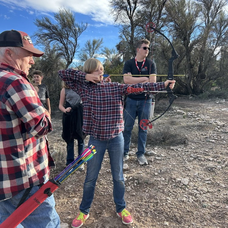 student aiming bow