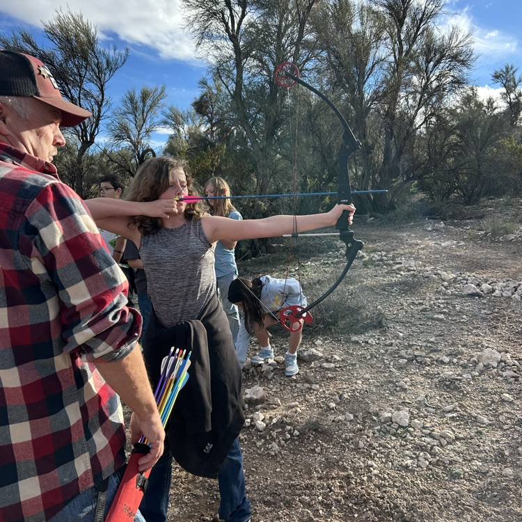 student aiming bow