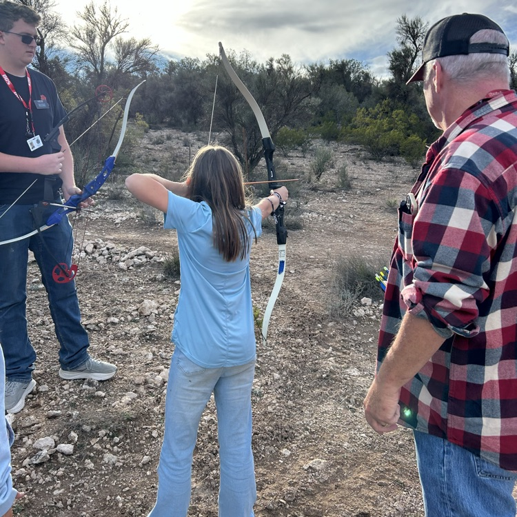 student aiming bow