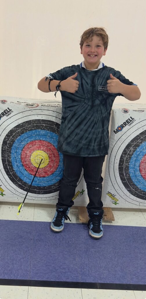 Students first bullseye in archery class