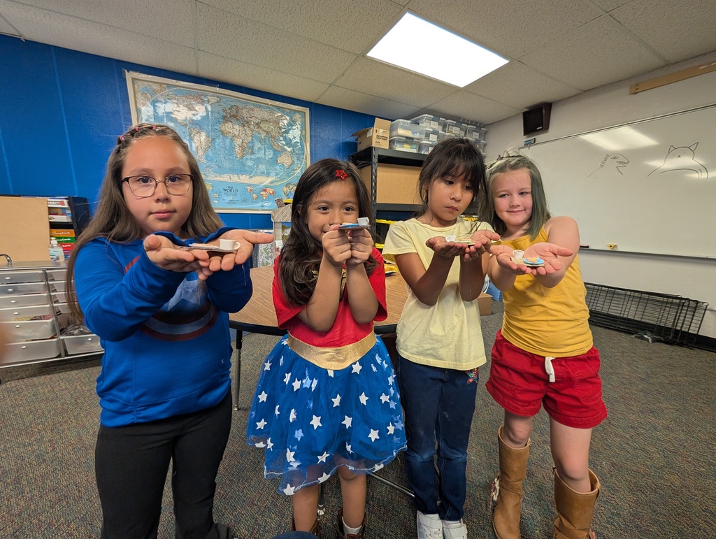 students proudly displaying their miniature cafes