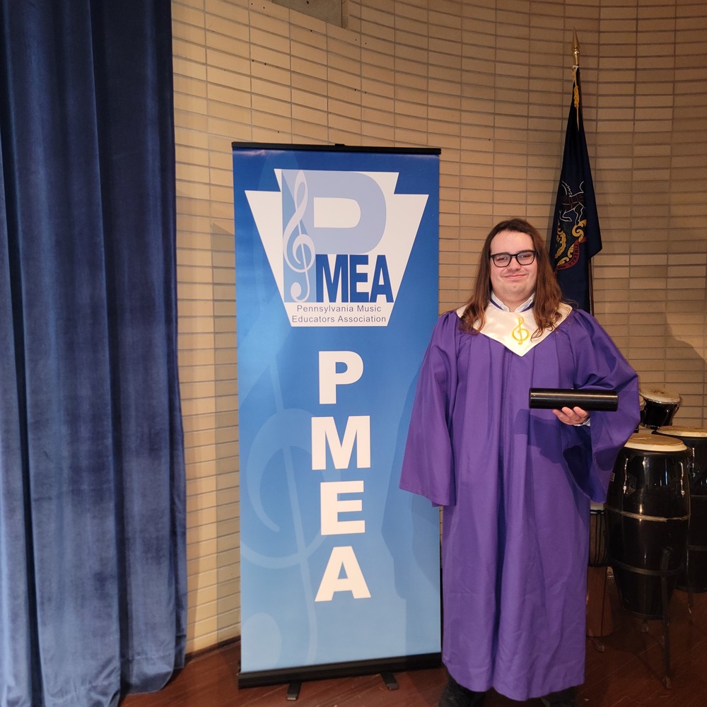 Student by the PMEA District Chorus Banner