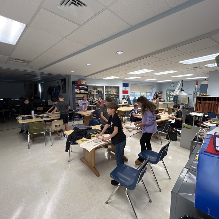 students in art working with clay  