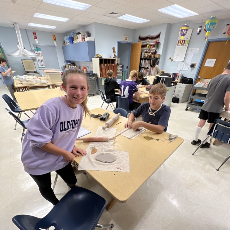 students working on their project at their table 