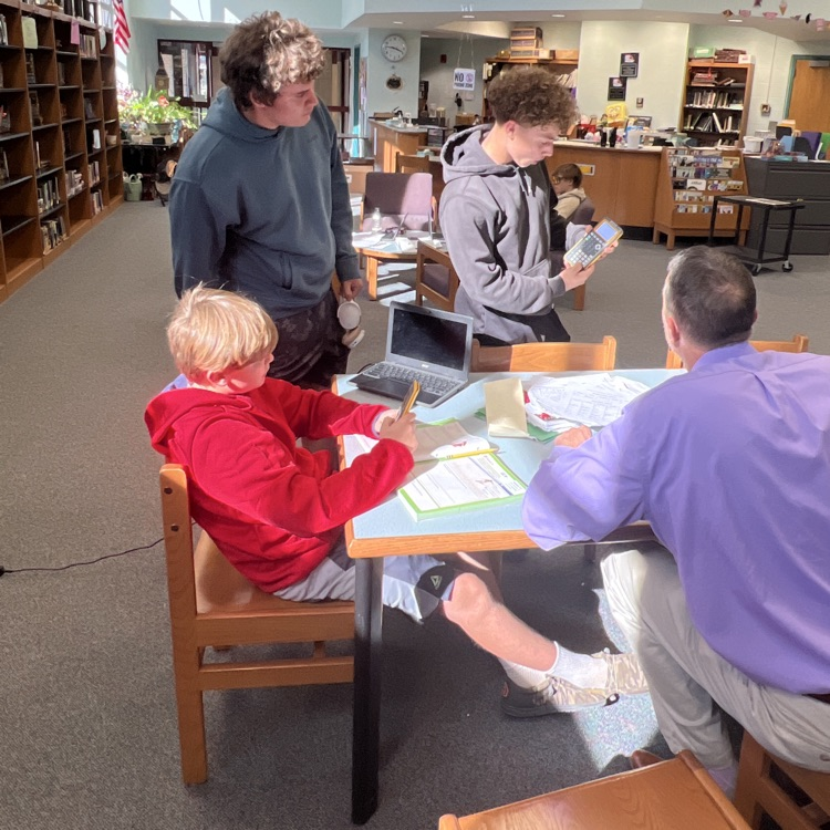 students helping explain how to do fractions on a calculator 