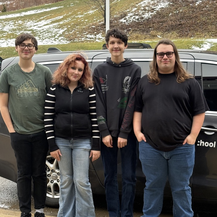 students posing by a van on their way to District Chorus