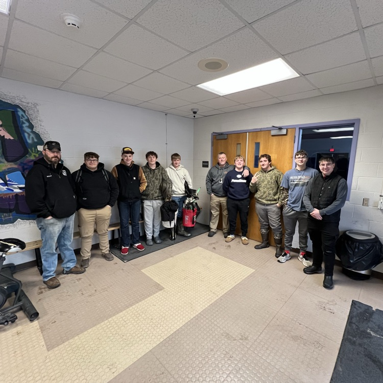 students standing by a wall before going on a fishing trip 
