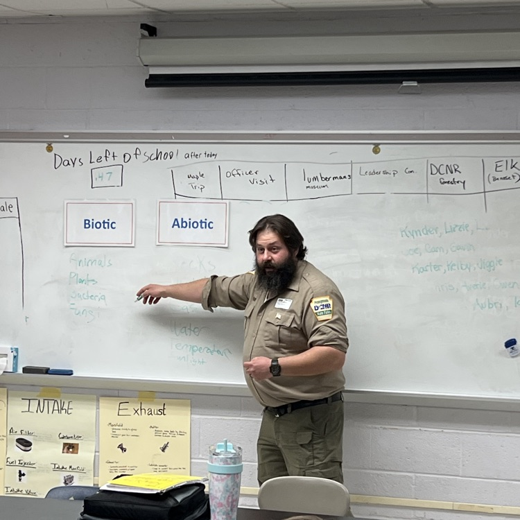 State plank Environmental Educator at a white board.