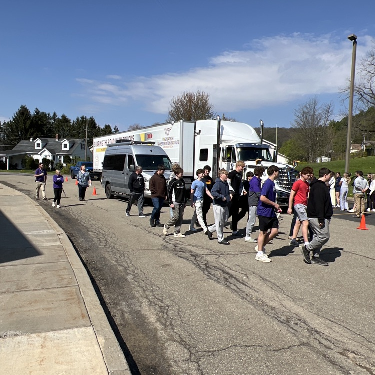 students by a tractor trailer.  