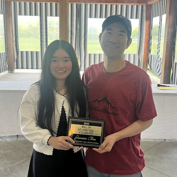 student and parent with an award.