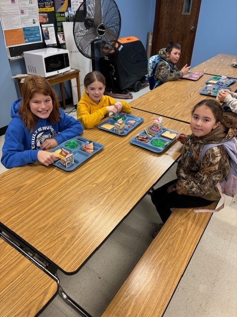 Elementary students enjoying green eggs and ham.