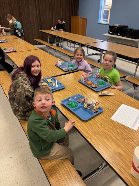 Elementary students enjoying green eggs and ham.