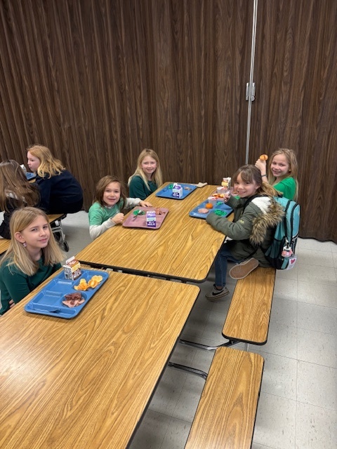 Elementary students enjoying green eggs and ham.