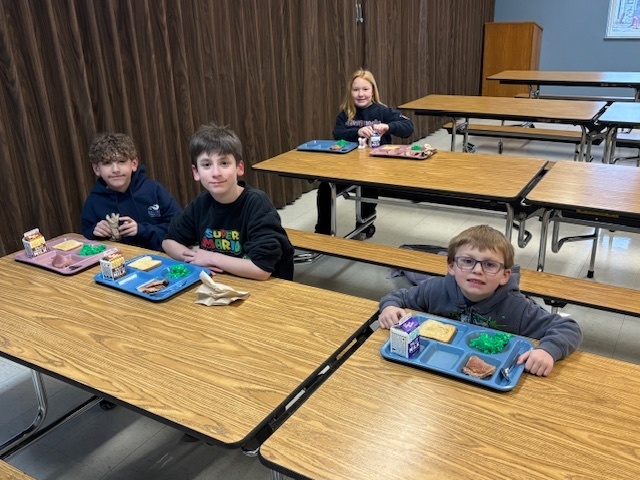 Elementary students enjoying green eggs and ham.