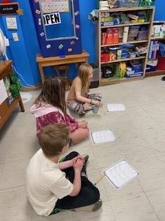 Fourth Grade: Emmillee, Kailan, and Michael mastering the bottle flip activity in math class! 