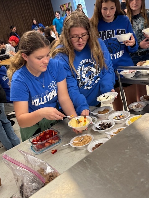 Ariel and Dessa adding toppings