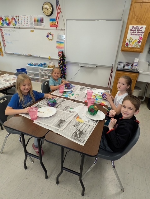 1st grade working on paper mache