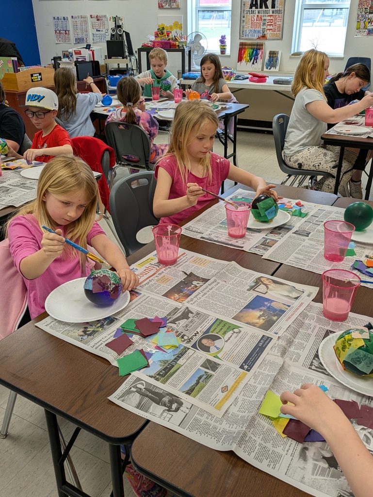 Third grade class working on paper mache Easter eggs
