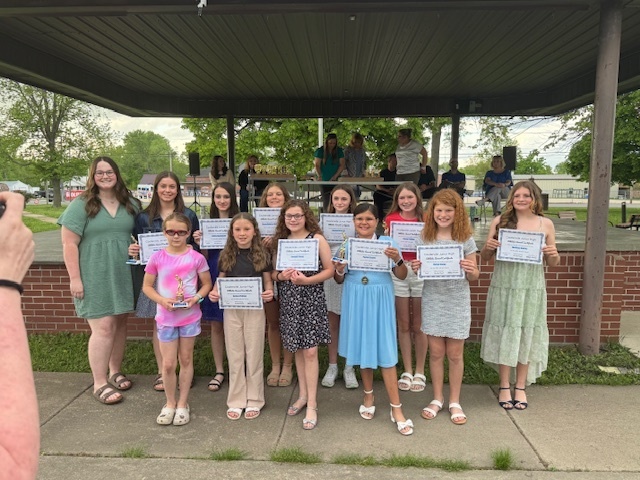 Softball players with their awards.