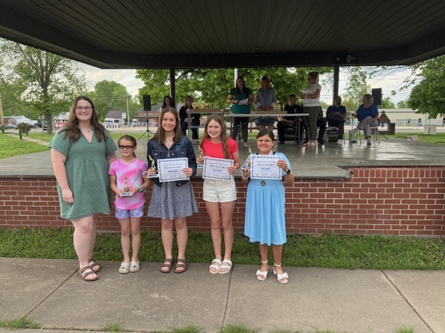 Softball players with their awards.