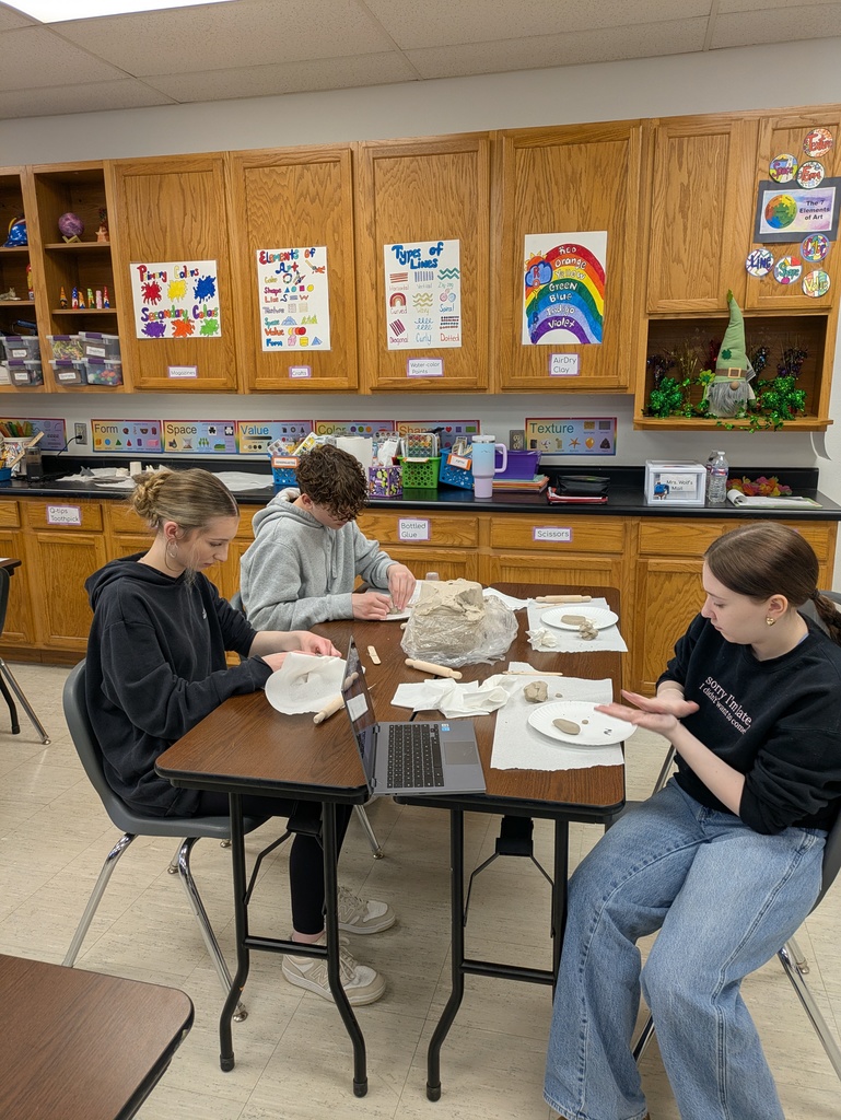 high school students creating 3d objects for kiln