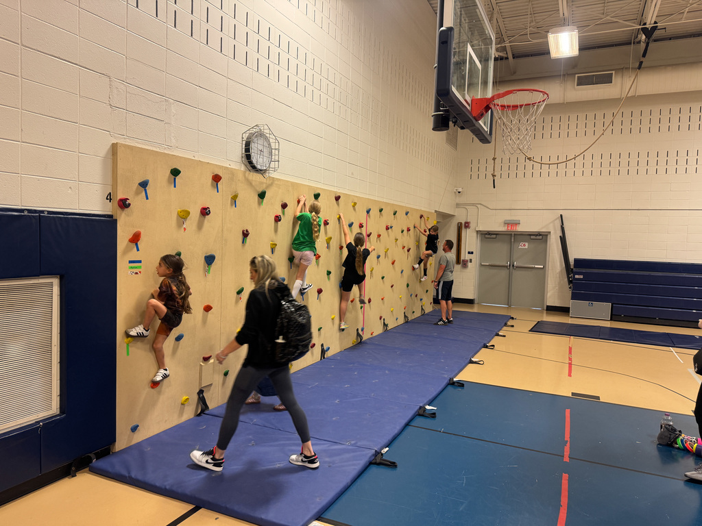 students engaging in climbing goodnoe's rock wall