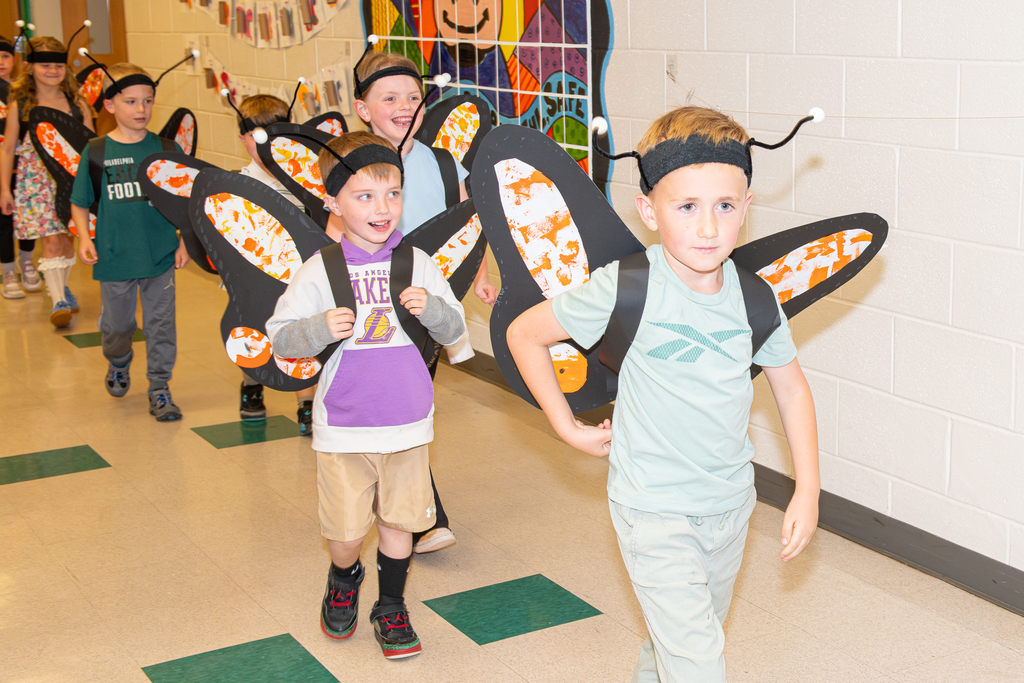 Students walking down the hall to release butterflies