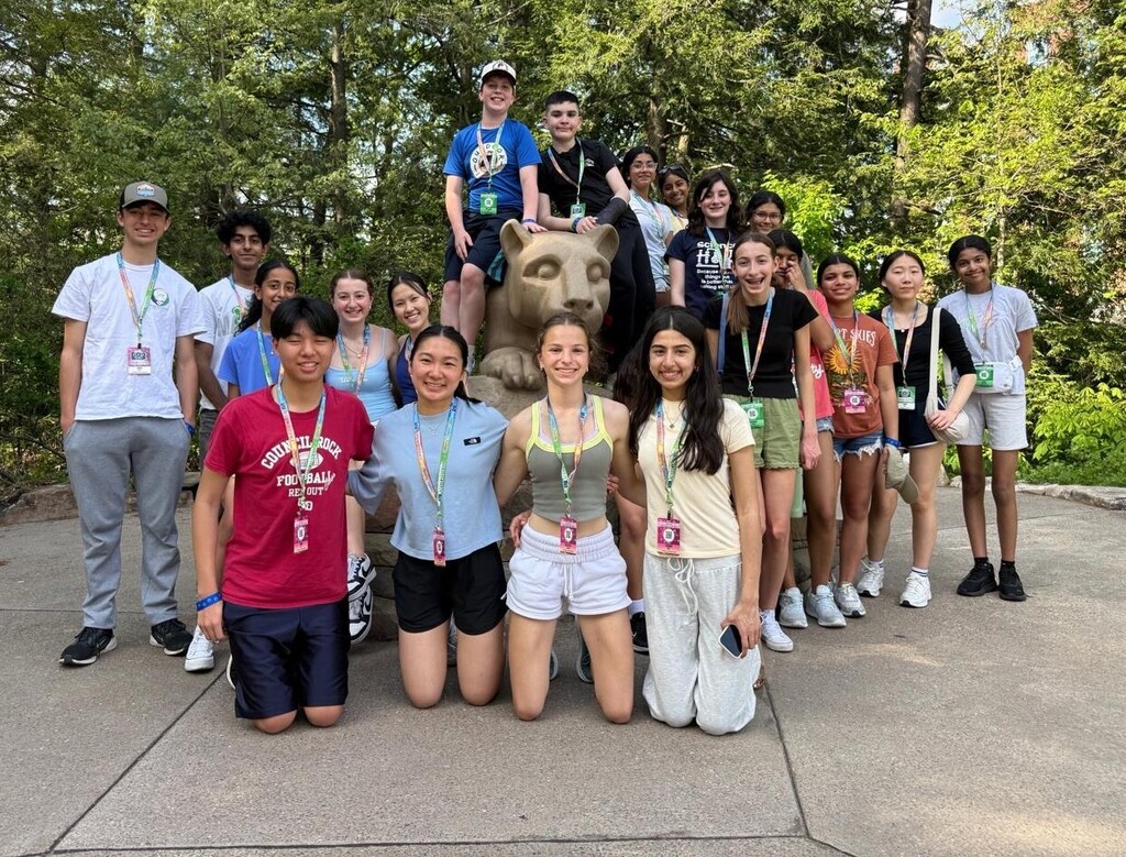 students standing at the nittany lion for a science fair competition