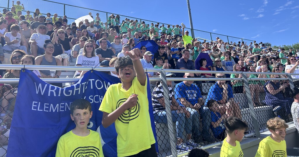 students cheering on their classmates at the 6th grade track meet