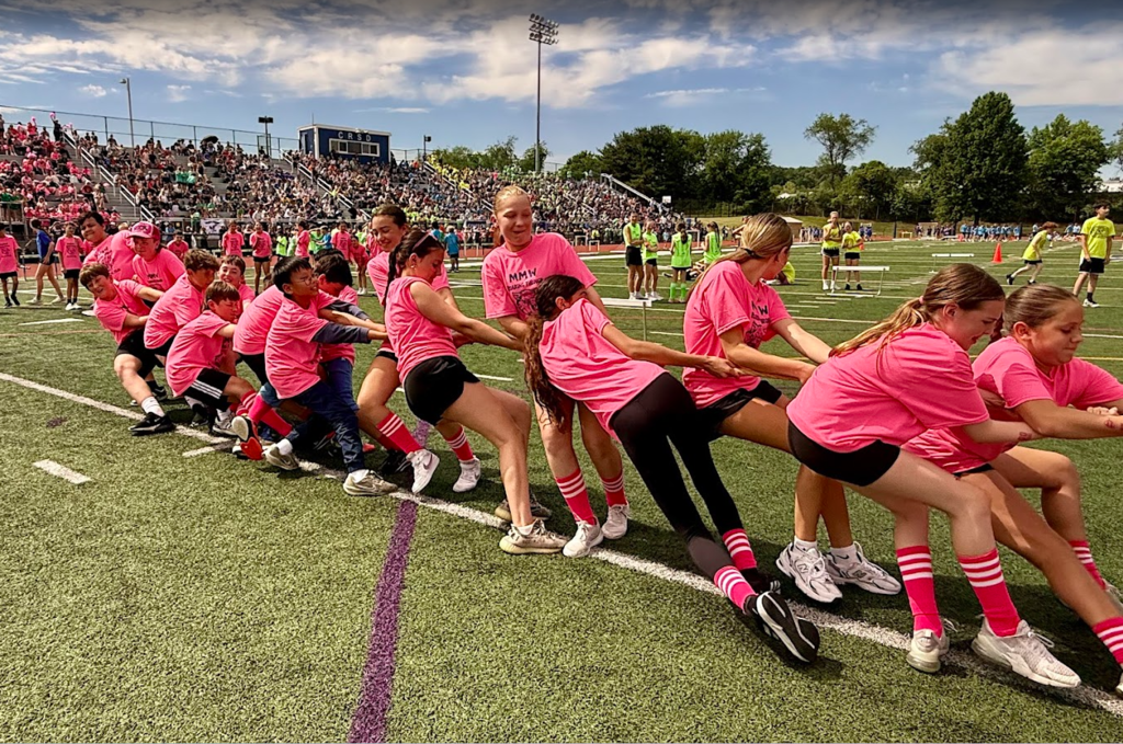 students participating in a tug of war at the 6th grade track meet