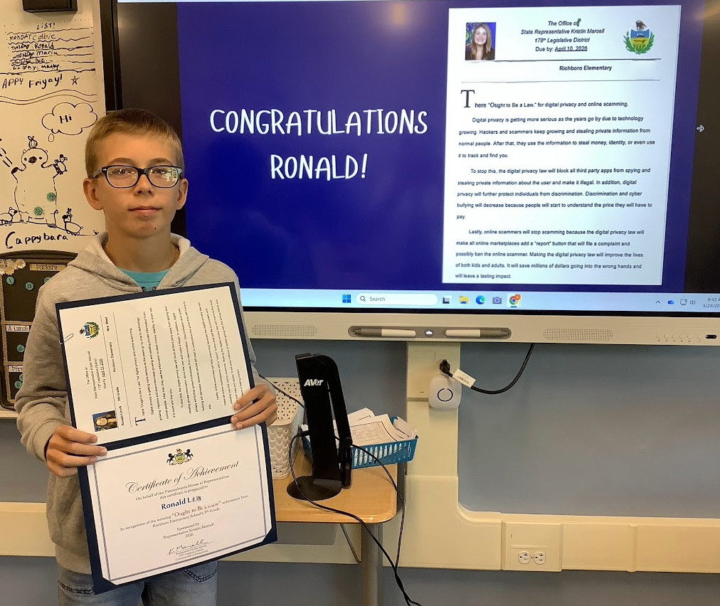 Student receiving an award for a proposed law