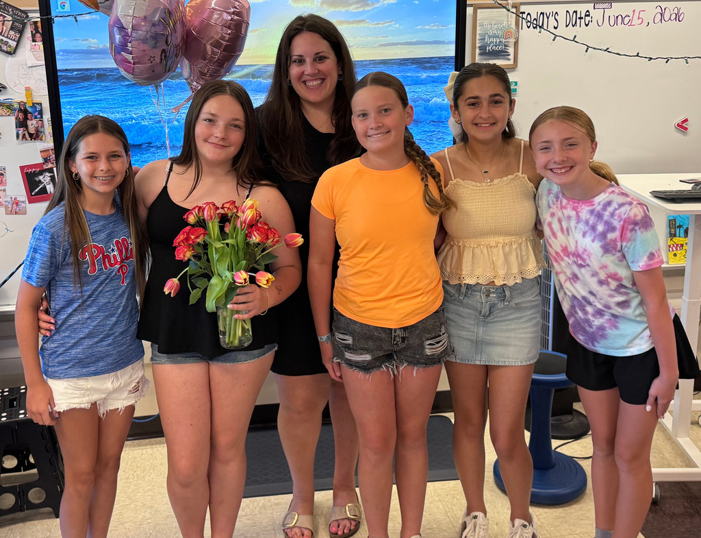 teacher and 5 students smiling for the last day