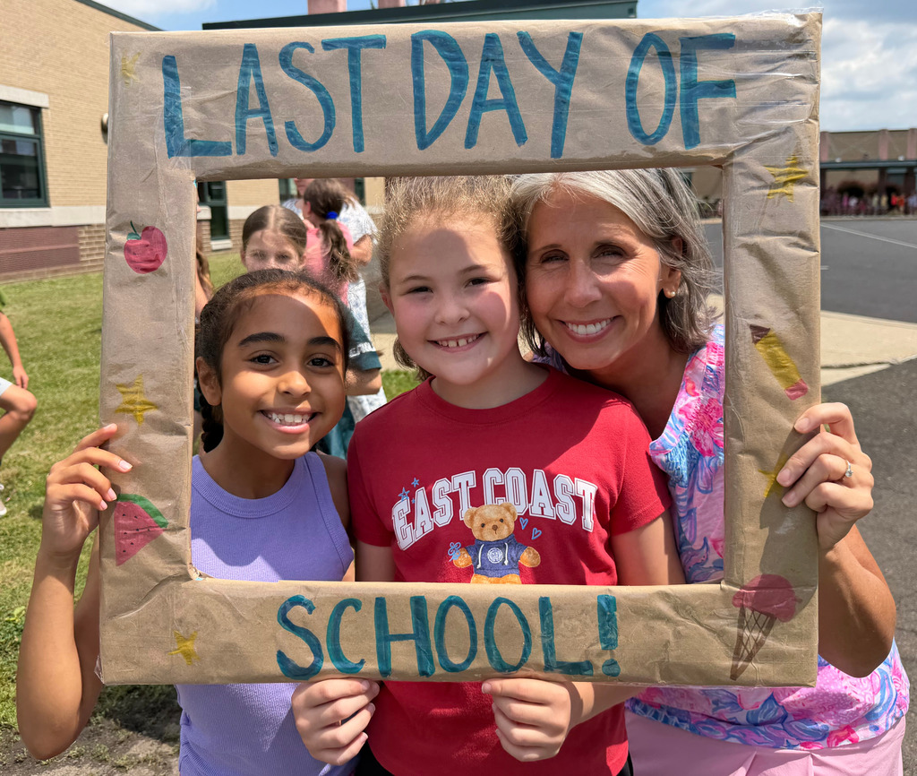 students and teacher smiling in a frame that says 'Last Day of School'
