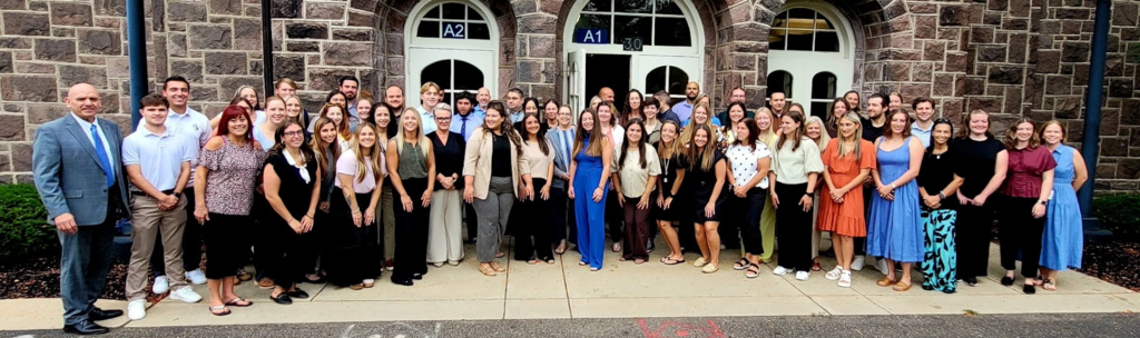 Image of new staff standing in front of Chancellor Center