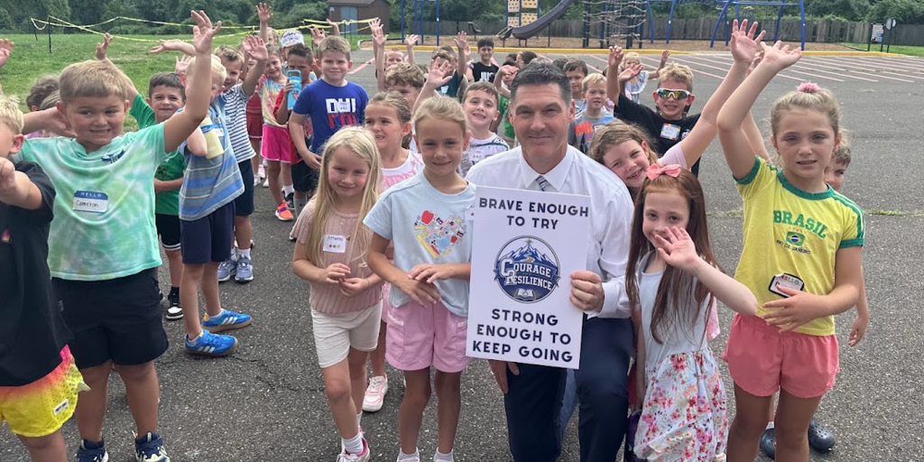 Mr. Harlan with first grade students at recess on August 31, 2026