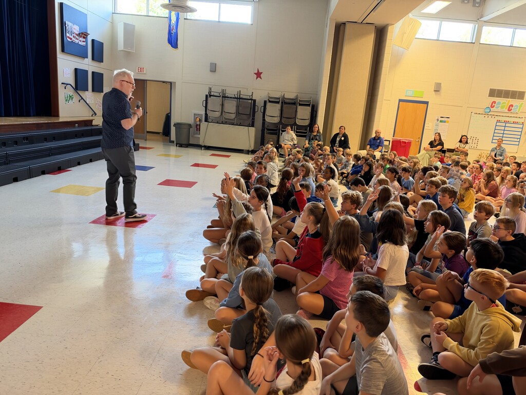 students asking questions of an author