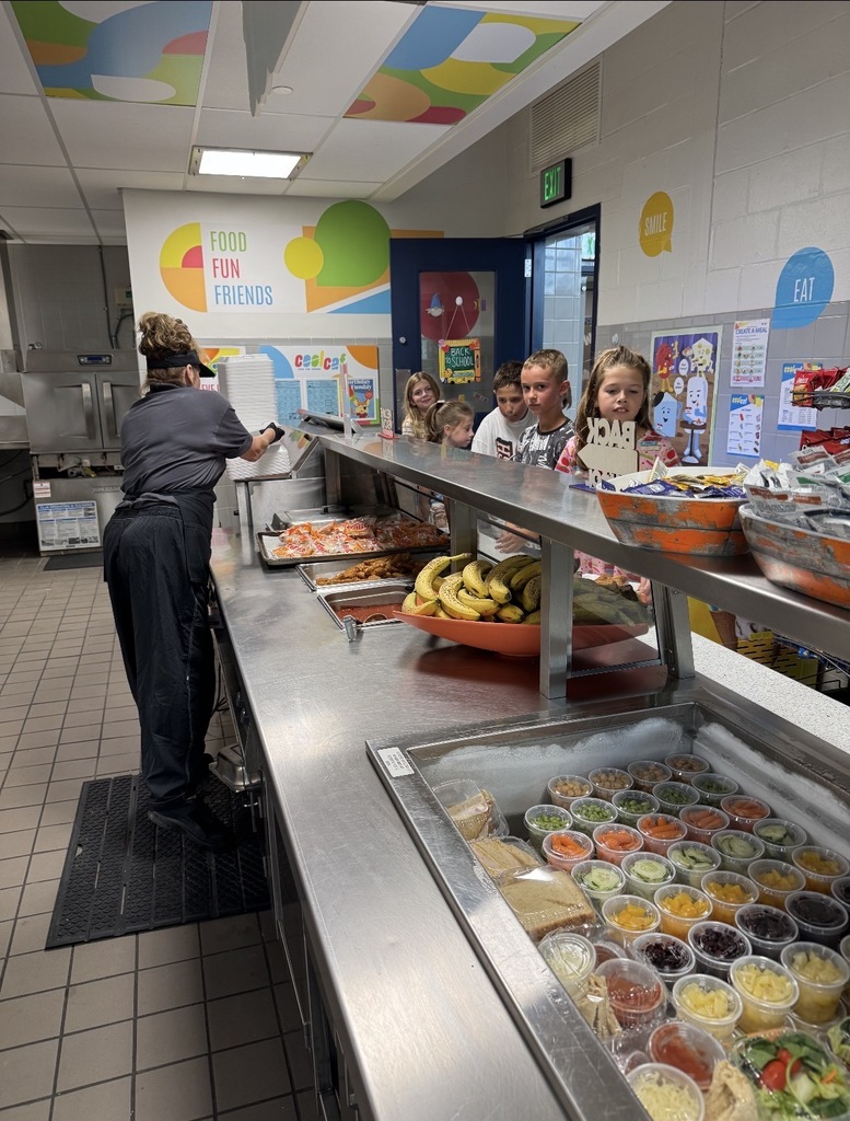 Cafeteria lunch line with food in serving cups