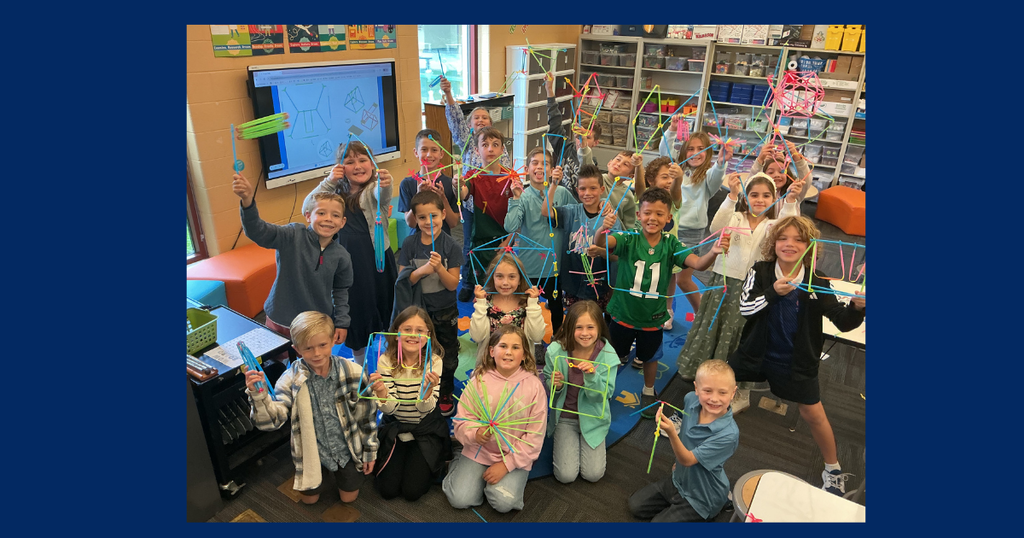students standing in a group showing their STEAM projects they are working on